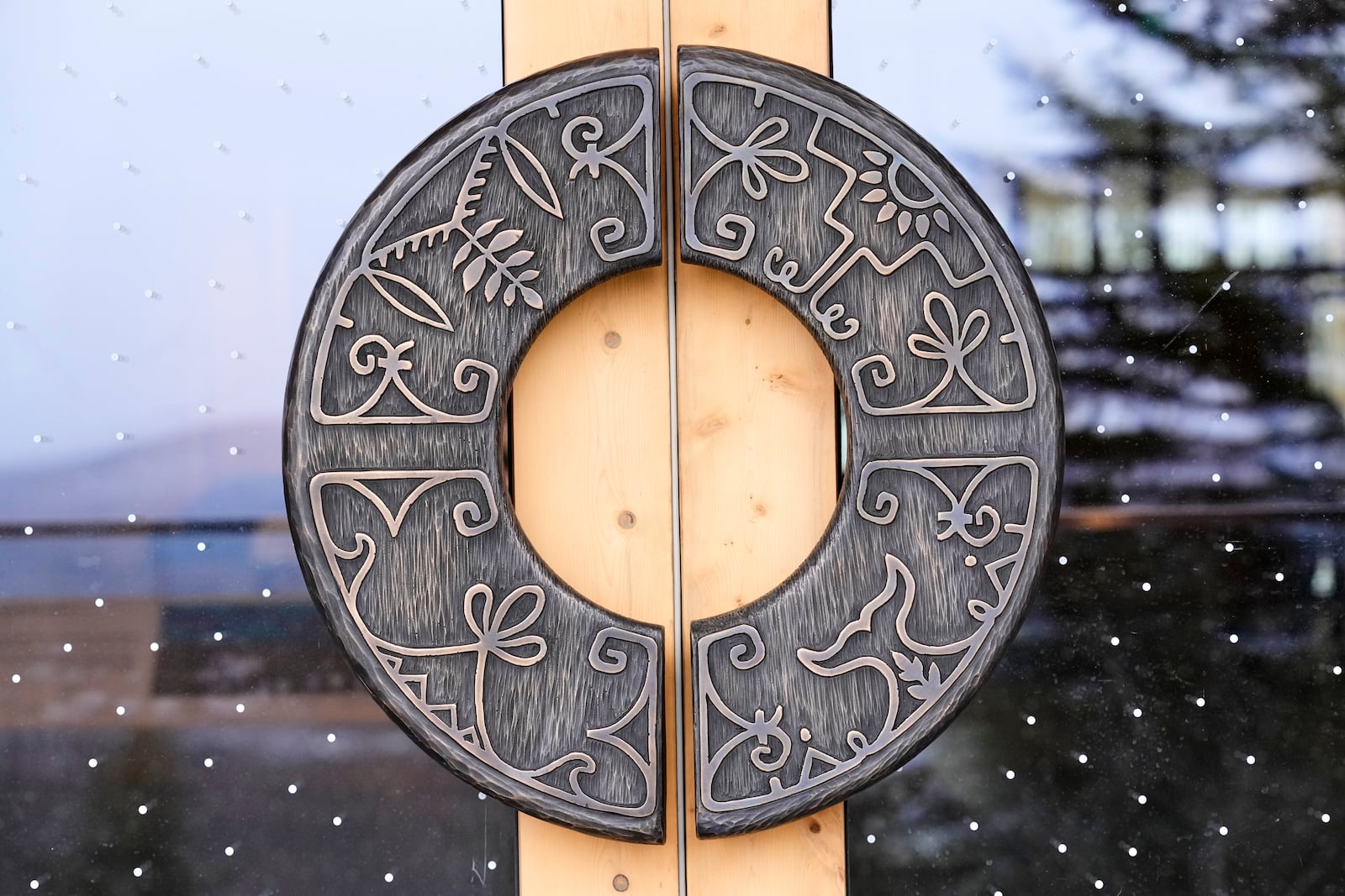 Wabanaki artistry is seen on the on door handles at the Tekakapimək Contact Station, Jan. 7, 2025, at the Katahdin Woods and Waters Monument in northern Maine. (AP Photo/Robert F. Bukaty)