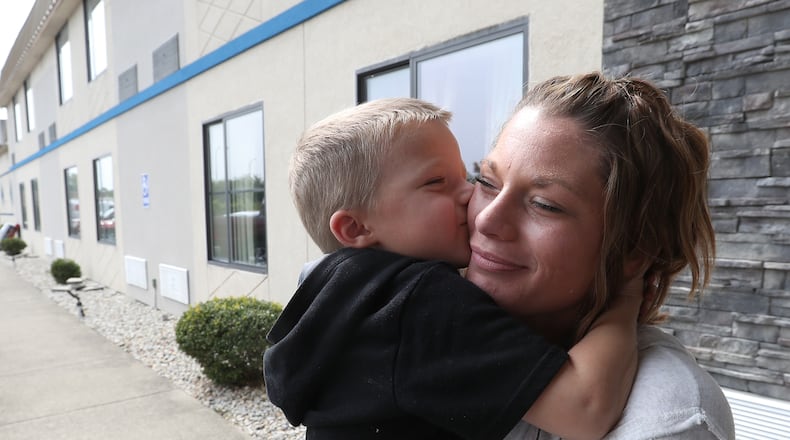 Julie Johns gets a kiss from her son, Maddox, outside the Motel 6 where they are currently living. According to Julie, they were homeless until the Interfaith Hospitality Network helped them and set them up in the motel. BILL LACKEY/STAFF