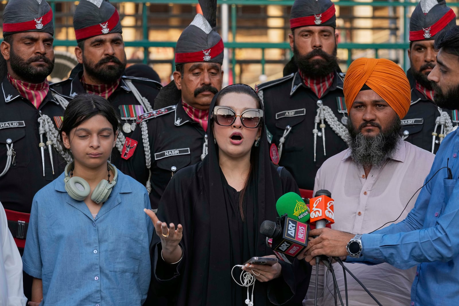 Mushaal Hussein, center, the wife of a top Kashmiri rebel leader, Mohammed Yasin Malik, talks to media as her daughter Razia Sultan, left, watches, at the Wagah, a joint post on the Pakistan and India border, near Lahore, Pakistan, Monday, May 5, 2025. (AP Photo/K.M. Chaudary)