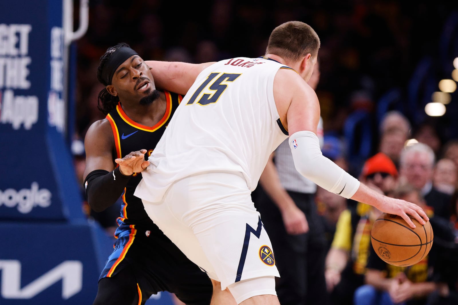 Oklahoma City Thunder guard Luguentz Dort (5) takes an elbow to the back of the head from Denver Nuggets' Nikola Jokic (15) in the second half of Game 1 of an NBA basketball second-round playoff series Monday, May 5, 2025, in Oklahoma City. (AP Photo/Nate Billings)