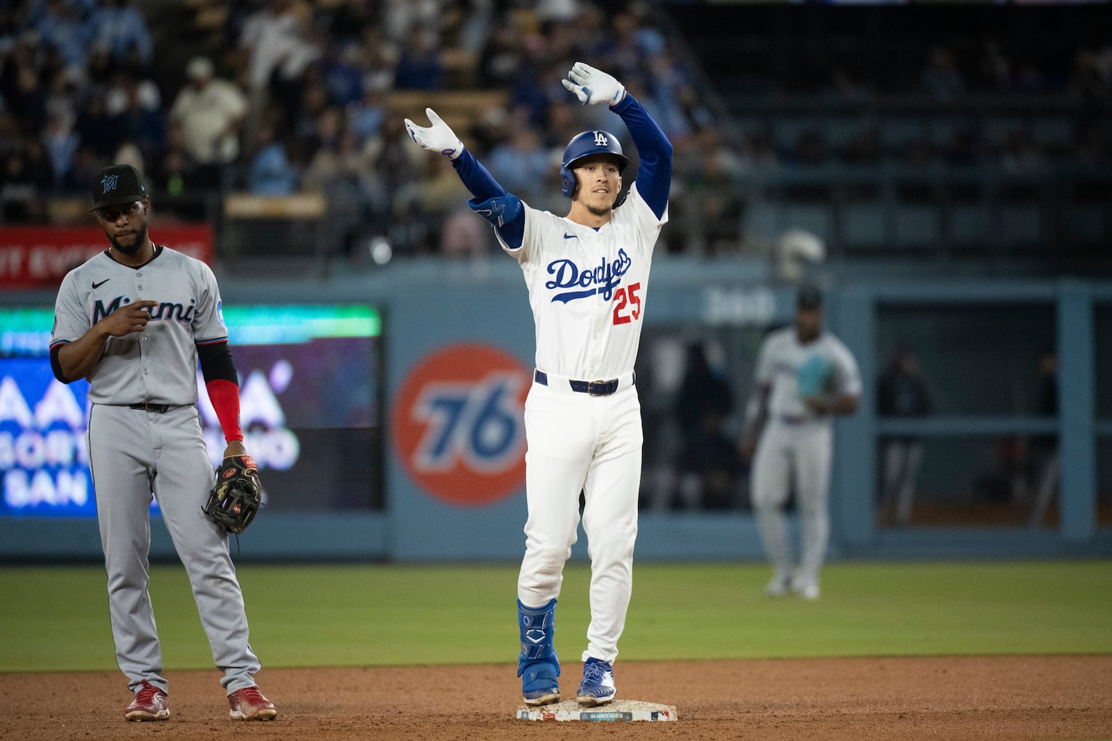 Los Angeles Dodgers' Tommy Edman, right, celebrates his two-run double during the sixth inning of a baseball game against the Miami Marlins in Los Angeles, Tuesday, April 29, 2025. (AP Photo/Kyusung Gong)