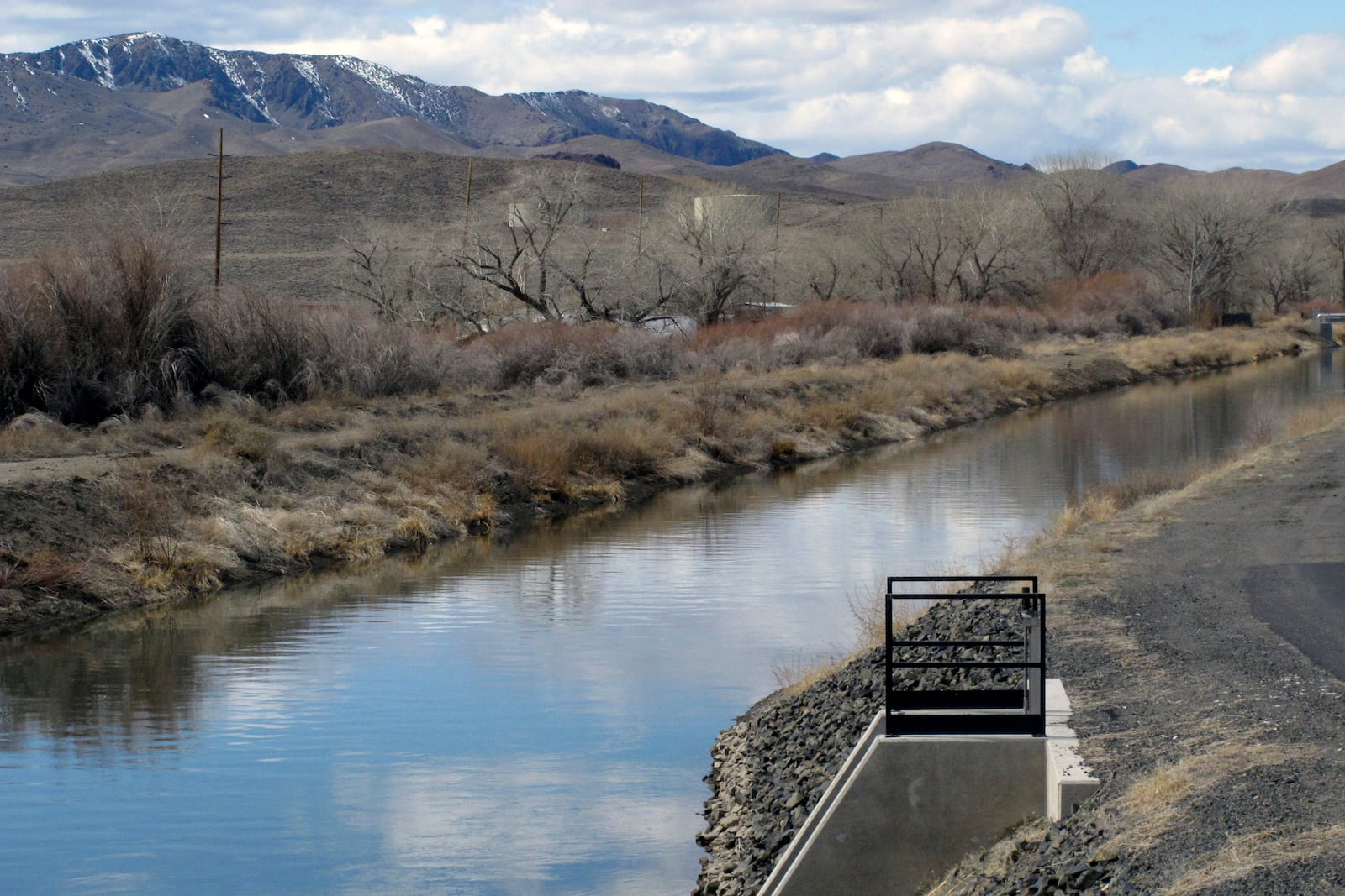 FILE — The view of an irrigation canal in Fernley, Nev. near Reno, March 18, 2021. (AP Photo/Scott Sonner, File)