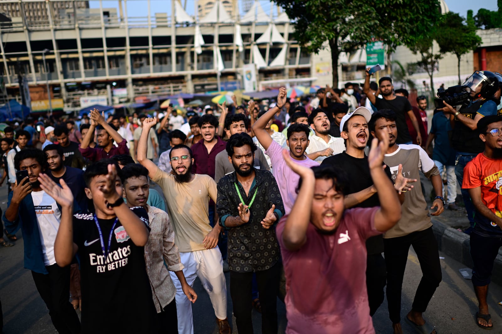 Students shout slogans during a protest near secretariat against the crash of a Bangladesh air force training jet into a school, demanding accountability, compensation for victims' families and the halt of training flights, in Dhaka, Bangladesh, Tuesday, July 22, 2025. (AP Photo/Mahmud Hossain Opu)