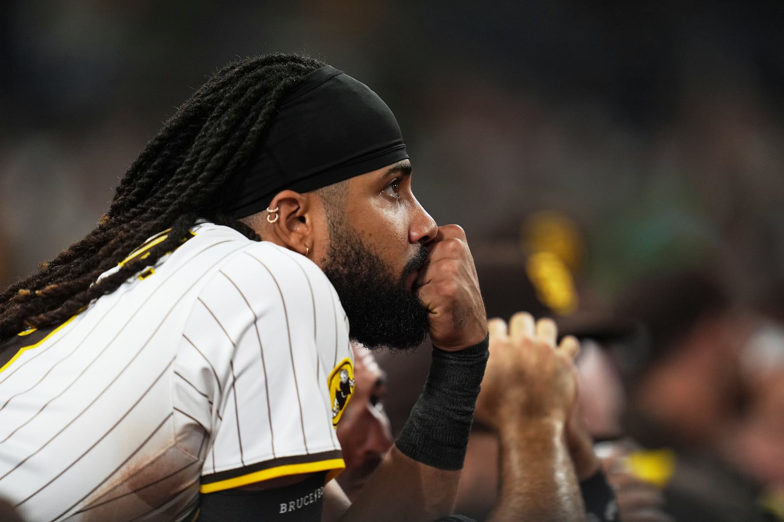 San Diego Padres right fielder Fernando Tatis Jr. looks on from the dugout during the ninth inning of a baseball game against the Cincinnati Reds Monday, Sept. 8, 2025, in San Diego. (AP Photo/Gregory Bull)