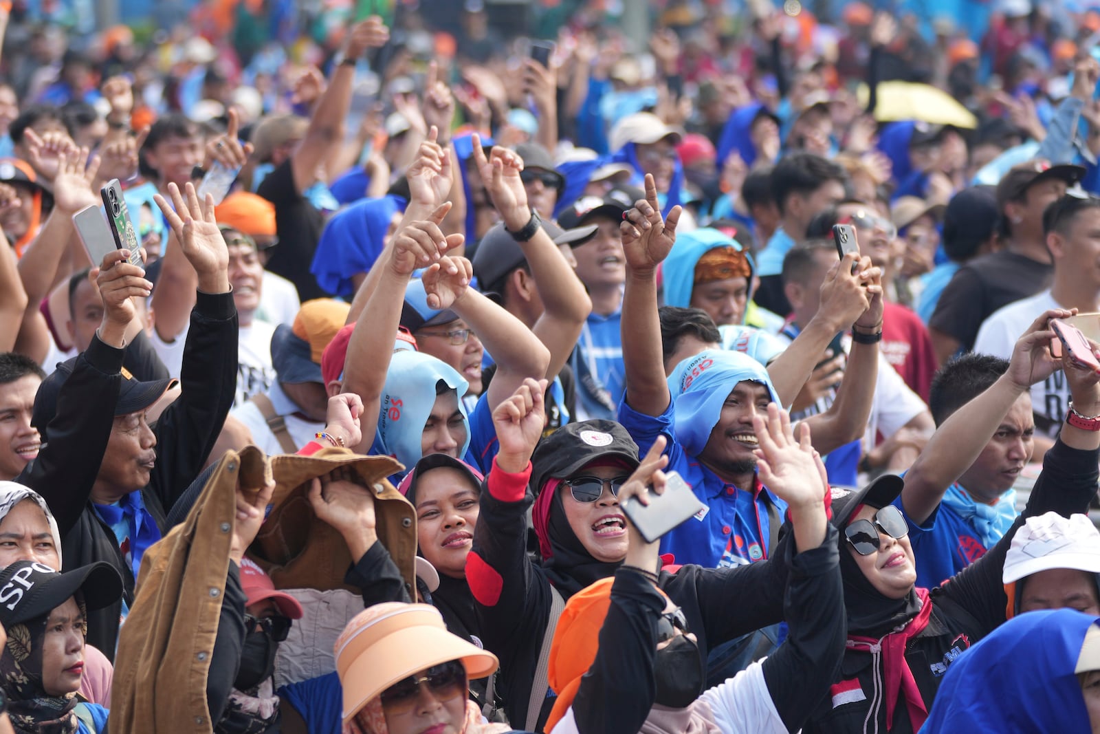 The crowd cheer during a May Day rally at the National Monument in Jakarta, Indonesia, Thursday, May 1, 2025. (AP Photo/Tatan Syuflana)