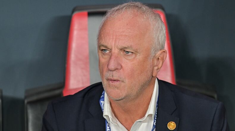 FILE- Iraqi's head coach Graham Arnold sits on the bench at the start of the 2026 World Cup play off first leg soccer match between UAE and Iraq in Abu Dhabi, United Arab Emirates, Friday, Nov. 14, 2025. (AP Photo/Walid Ibrahim, File)
