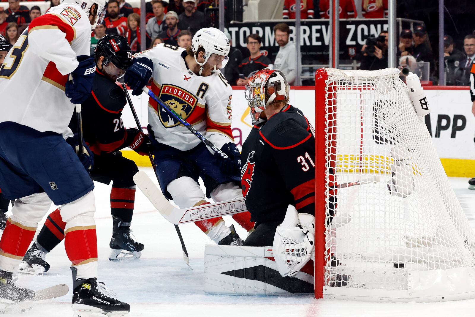 Florida Panthers' Matthew Tkachuk (19) slips the puck past Carolina Hurricanes goaltender Frederik Andersen (31) for a goal during the first period of Game 2 of the NHL hockey Stanley Cup Eastern Conference finals in Raleigh, N.C., Thursday, May 22, 2025. (AP Photo/Karl DeBlaker)