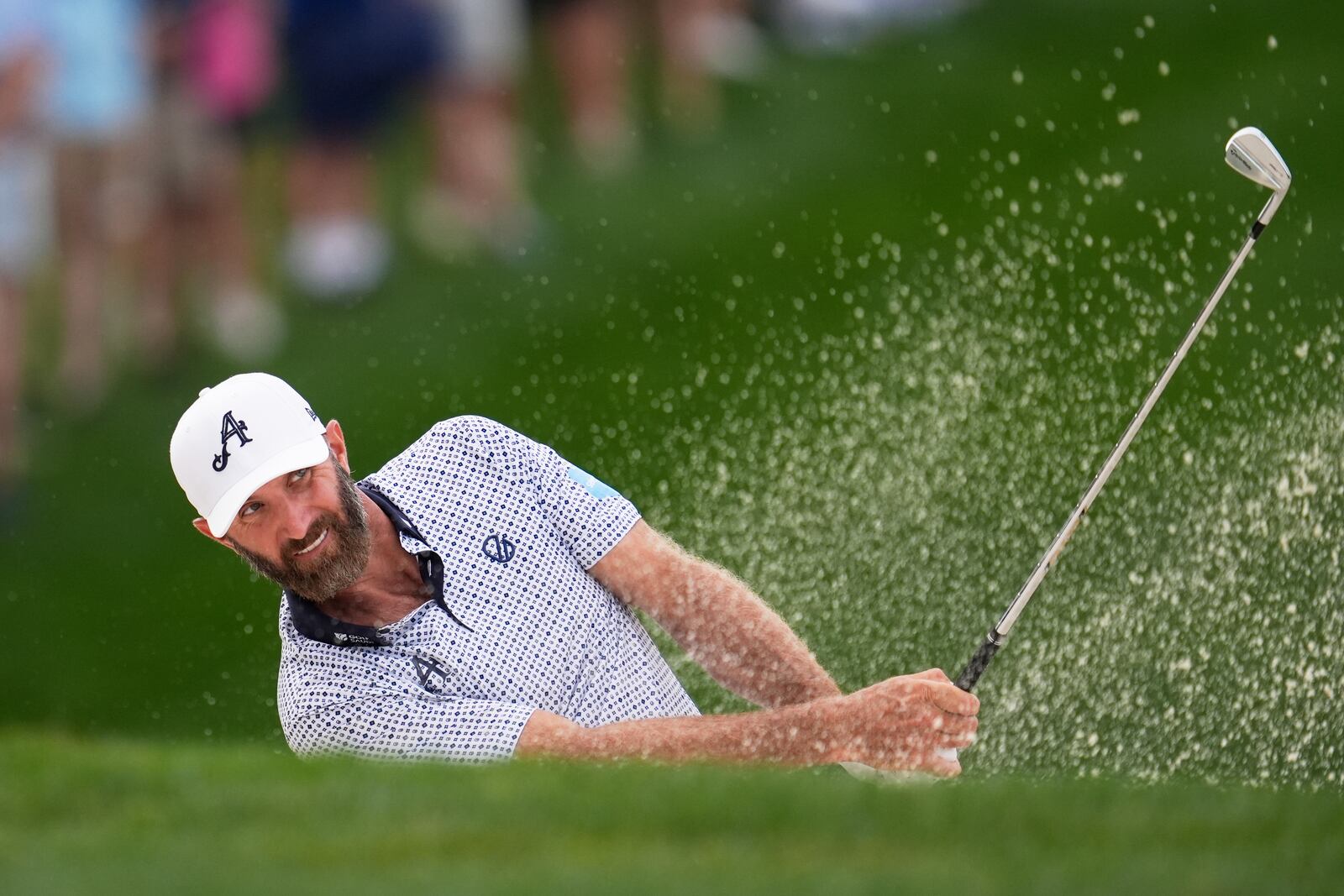 Dustin Johnson hits from the bunker on the 14th hole during the second round of the PGA Championship golf tournament at the Quail Hollow Club, Friday, May 16, 2025, in Charlotte, N.C. (AP Photo/George Walker IV)