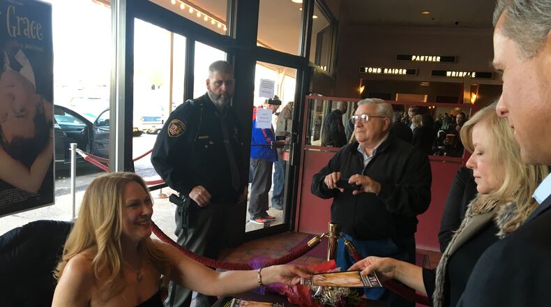 Actress Marsha Dietlein Bennett, a 1983 North High School graduate, autographs a photo on Friday, March 23 prior to a showing of her new film, “Getting Grace” at Chakeres Cinema 10. Photo by Brett Turner