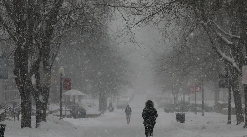 Wittenberg University will operate remotely on Thursday due to winter storm. Here, students walked through the snow on the Wittenberg University campus last year during a snow storm. BILL LACKEY/STAFF