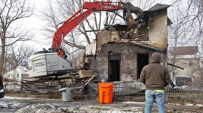 A demolition crew tears down a house in the 800 block of Linden Avenue in Springfield Monday, Jan. 22, 2024 after an early morning fire gutted the structure and made it unsafe. BILL LACKEY/STAFF