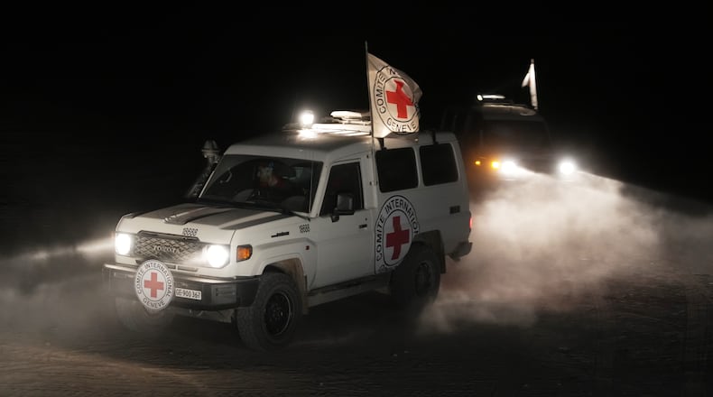 Red Cross vehicles carrying the bodies of three people believed to be deceased hostages handed over by Hamas make their way toward the border crossing with Israel, to be transferred to Israeli authorities, in Deir al-Balah, central Gaza Strip, Sunday, Nov. 2, 2025. (AP Photo/Jehad Alshrafi)