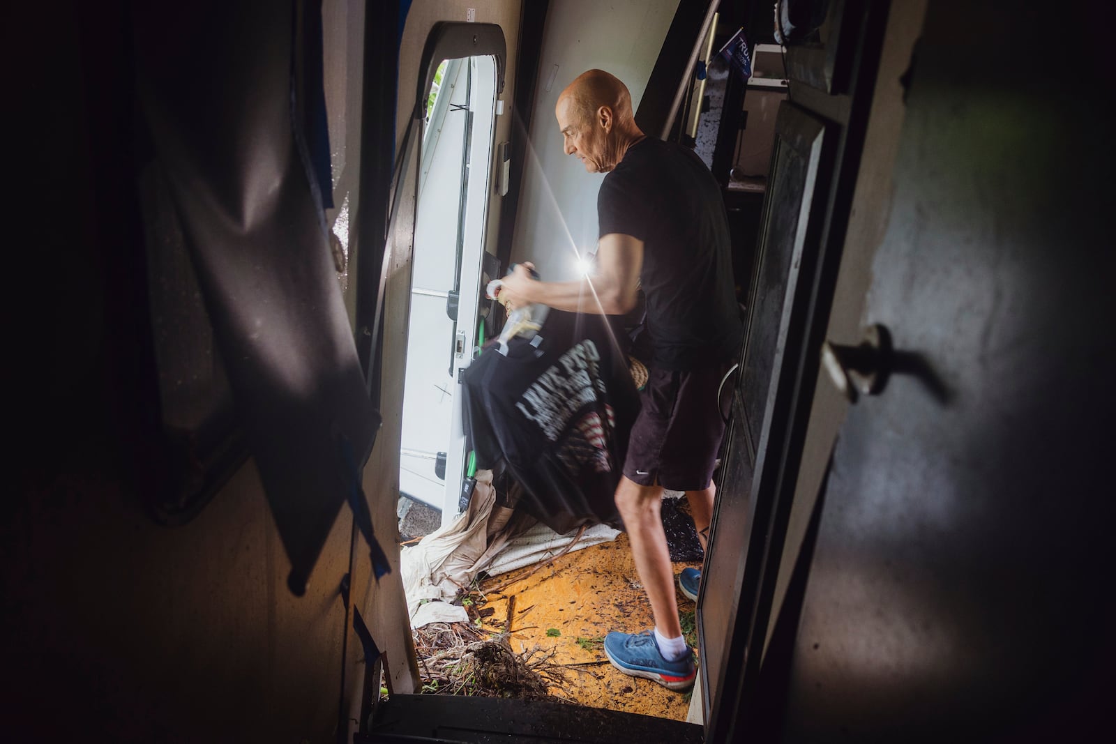 Thomas Rux, a resident of Riverside RV Park, goes through the wreckage of his RV that was swept away by floodwaters in Ingram, Texas, on Friday, July 4, 2025. (Christopher Lee/The San Antonio Express-News via AP)
