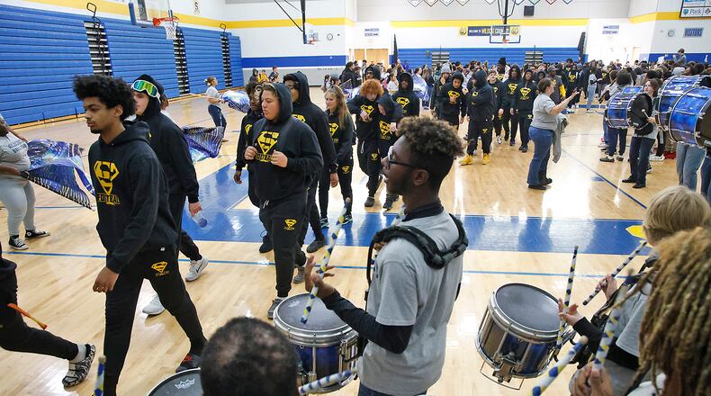 The Springfield High School Marching Band plays and the studens and staff cheer as the Wildcats walk through the school's halls and gymnasium and are sent off Thursday, Nov. 30, 2023 for the Division I State Championship in Canton. BILL LACKEY/STAFF