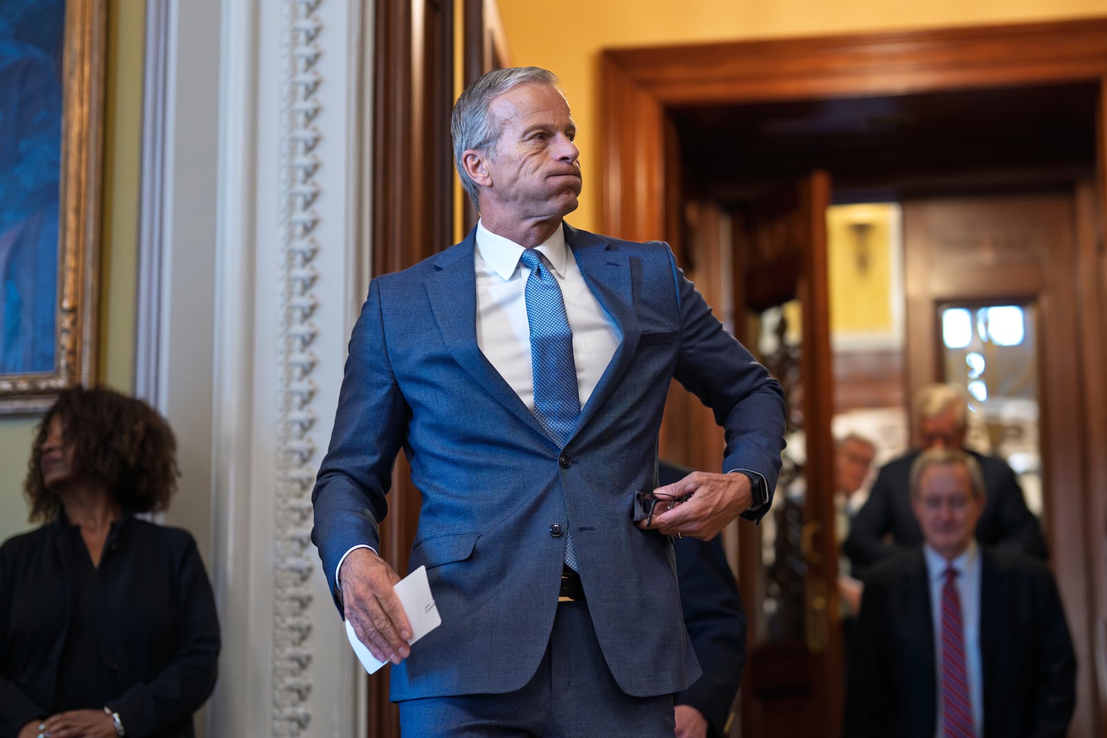 Senate Majority Leader John Thune, R-S.D., emerges from the chamber just after passage of the budget reconciliation package of President Donald Trump's signature bill of big tax breaks and spending cuts, at the Capitol in Washington, Tuesday, July 1, 2025. (AP Photo/J. Scott Applewhite)