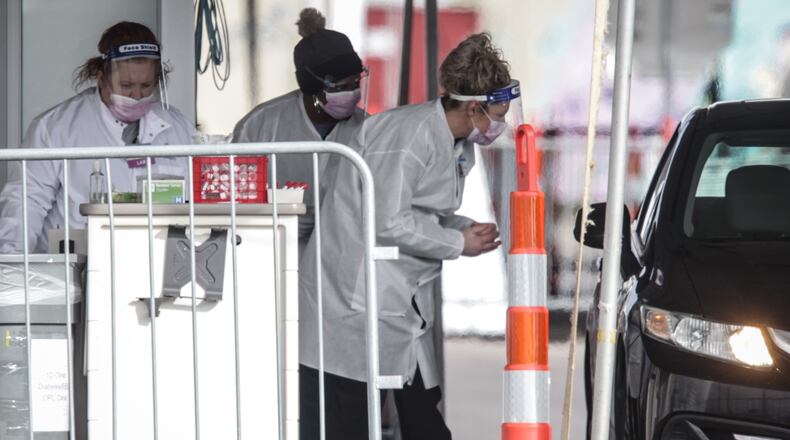 Nurses at Dayton Children's Hospital administer antigen test in their parking lot Tuesday Dec. 8, 2020. The hospital stated that results are available in four hours or less “which can help speed up isolation of contagious individuals and contact tracing, in the hopes of slowing the spread of the virus in our community.”