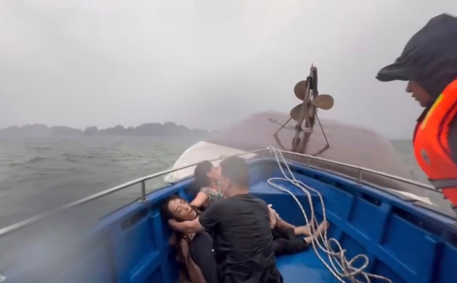 This image from a video provided by QDND shows people on a rescue boat after their tourist boat capsized in Ha Long Bay, Vietnam on Saturday, July 19, 2025. (QDND via AP)