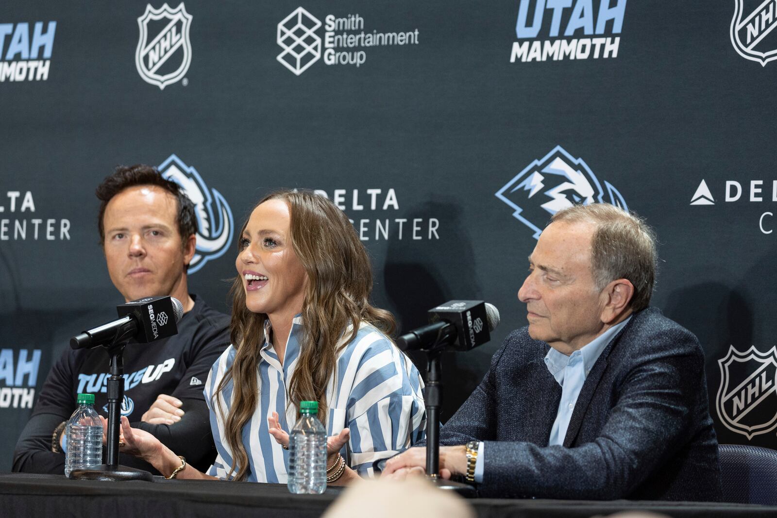 Chairman of Smith Entertainment Group Ryan Smith and co-founder Ashley Smith join NHL Commissioner Gary Bettman, from left, as they announce the Utah Mammoth as the new name and branding identity of Utah's NHL franchise, Wednesday, May 7, 2025, in Salt Lake City. (AP Photo/Melissa Majchrzak)