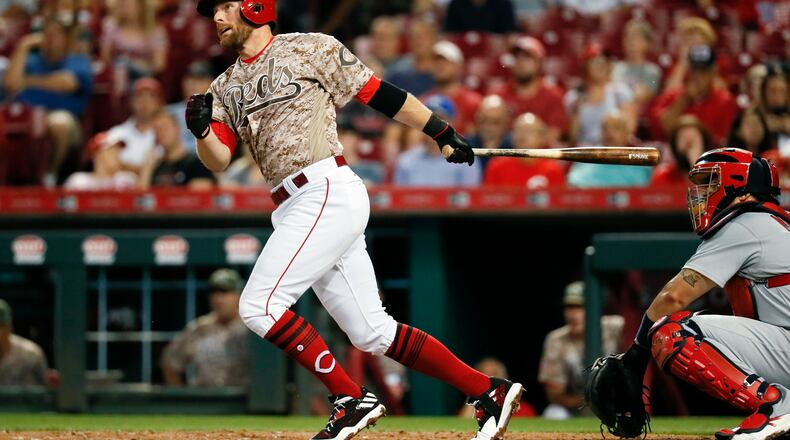 Cincinnati Reds’ Zack Cozart hits a two-run home run off St. Louis Cardinals relief pitcher John Gant in the third inning of a baseball game, Tuesday, Sept. 19, 2017, in Cincinnati. (AP Photo/John Minchillo)