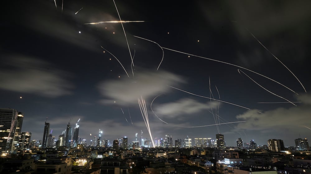 FILE - The Israeli Iron Dome air defense system intercepts missiles during an Iranian attack on Tel Aviv, Israel, June 18, 2025. (AP Photo/Leo Correa, File)
