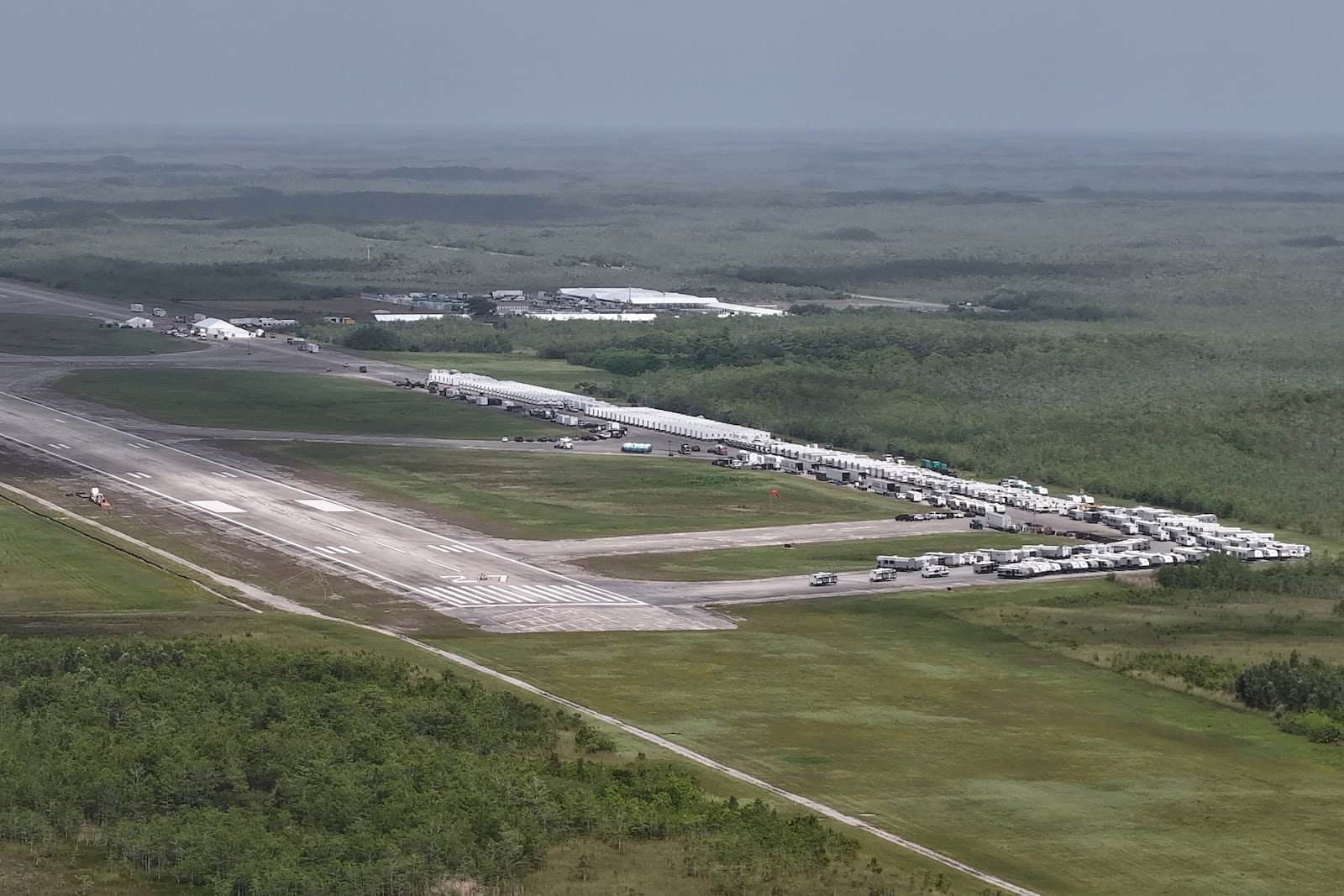 FILE - This aerial photo shows heavy-duty tents, trailers and other temporary buildings being built by the state for an immigration detention facility at the Miami Dade County-owned airfield in the Big Cypress National Preserve, about 45 miles west of downtown Miami, June 27, 2025. (AP Photo/Daniel Kozin, File)
