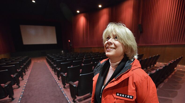 Sandi Arnold, executive director of the Champaign County Chamber of Commerce and Visitors Bureau, looks over the inside of the old Urbana theater Tuesday. The Urbana United Methodist Church plans to purchase the theater, add a cafe and a new performing arts center for the community. Bill Lackey/Staff