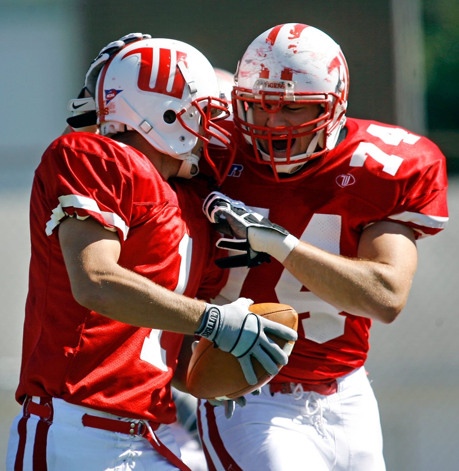 Patrick Williams (1) of Wittenberg University celebrates with B.J. Coad (74) after scoring a touchdown during Saturday's game against Wooster at Edwards Maurer Field.
Staff Photo by Barbara J. Perenic
