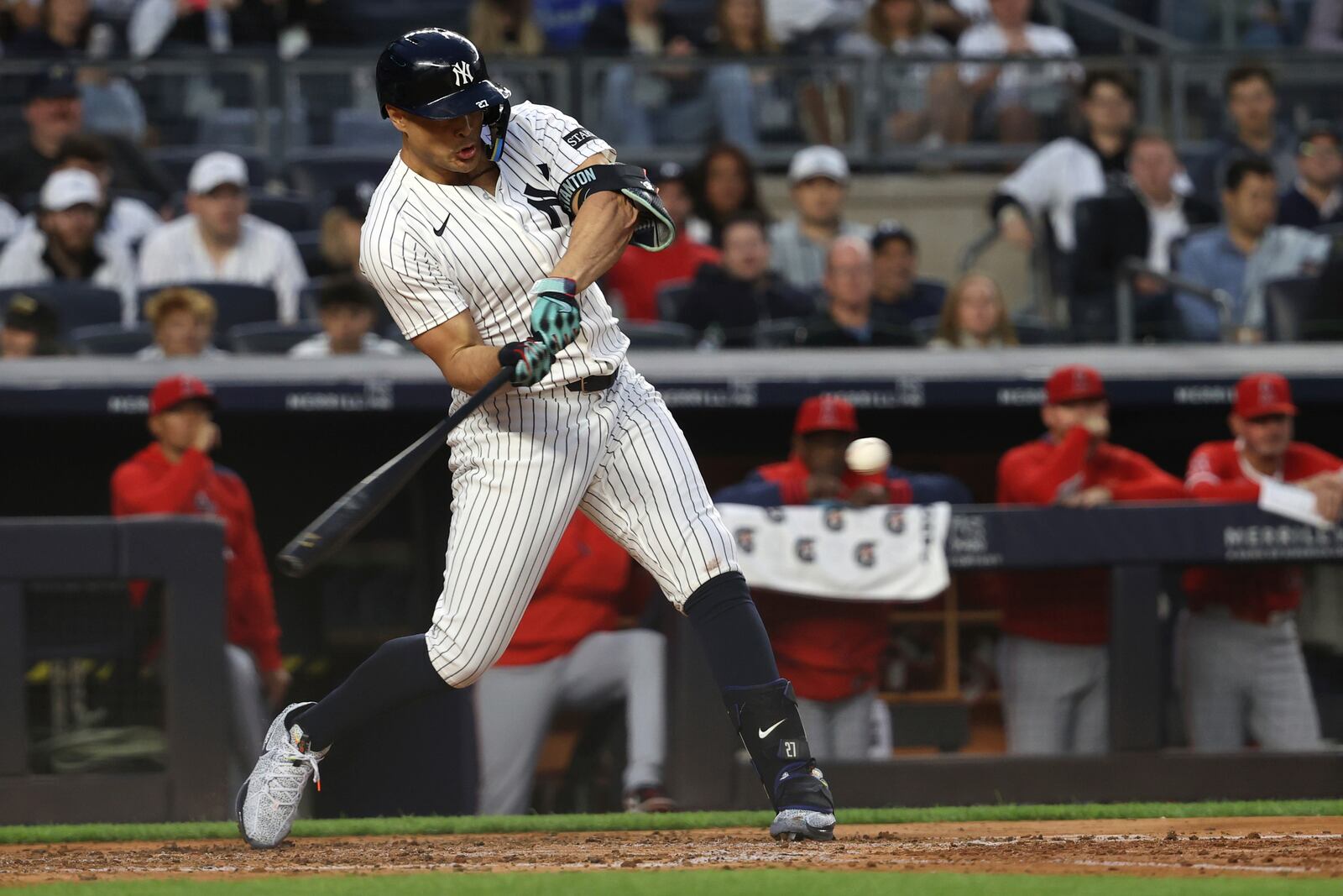 New York Yankees' Giancarlo Stanton hits a single during the fourth inning of a baseball game against the Los Angeles Angels, Monday, June 16, 2025, in New York. (AP Photo/Pamela Smith)