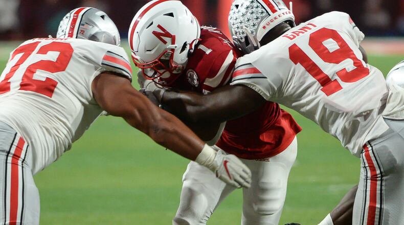 LINCOLN, NE - SEPTEMBER 28: Defensive tackle Tommy Togiai #72 of the Ohio State Buckeyes and linebacker Dallas Gant #19 combine to tackle wide receiver Wan'Dale Robinson #1 of the Nebraska Cornhuskers at Memorial Stadium on September 28, 2019 in Lincoln, Nebraska. (Photo by Steven Branscombe/Getty Images)