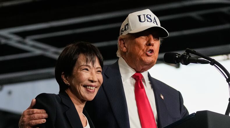 President Donald Trump, with Japanese Prime Minister Sanae Takaichi, speaks to members of the military aboard the USS George Washington, an aircraft carrier docked at an American naval base, in Yokosuka, Tuesday, Oct. 28, 2025. (AP Photo/Mark Schiefelbein)