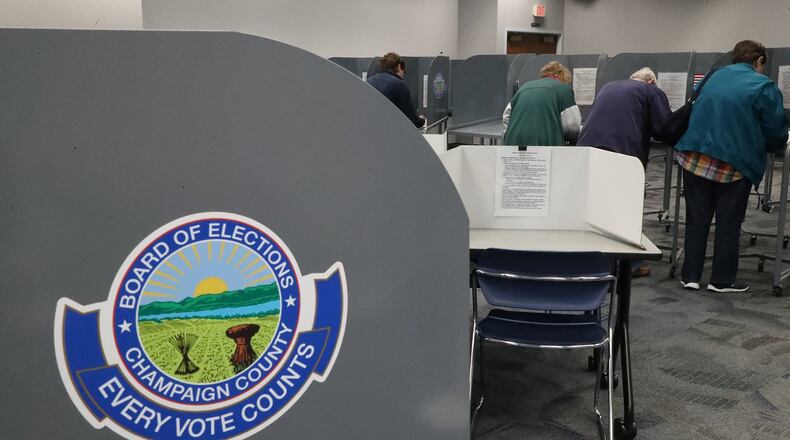 People cast their votes at the election poll in the Champaign County Government Center during last election. BILL LACKEY/STAFF