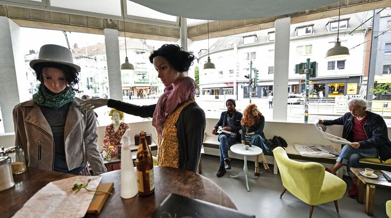 Display mannequins are placed between customers at the Cafe Livres in Essen, Germany, Wednesday, May 20, 2020. The cafe set the dolls as placeholders on various places for more distance between customers due to the new coronavirus orders for restaurants and cafes. (AP Photo/Martin Meissner)