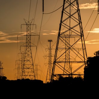 FILE – The sun sets behind power lines in Gaithersburg, Md., Oct. 23, 2020. (Samuel Corum/The New York Times)