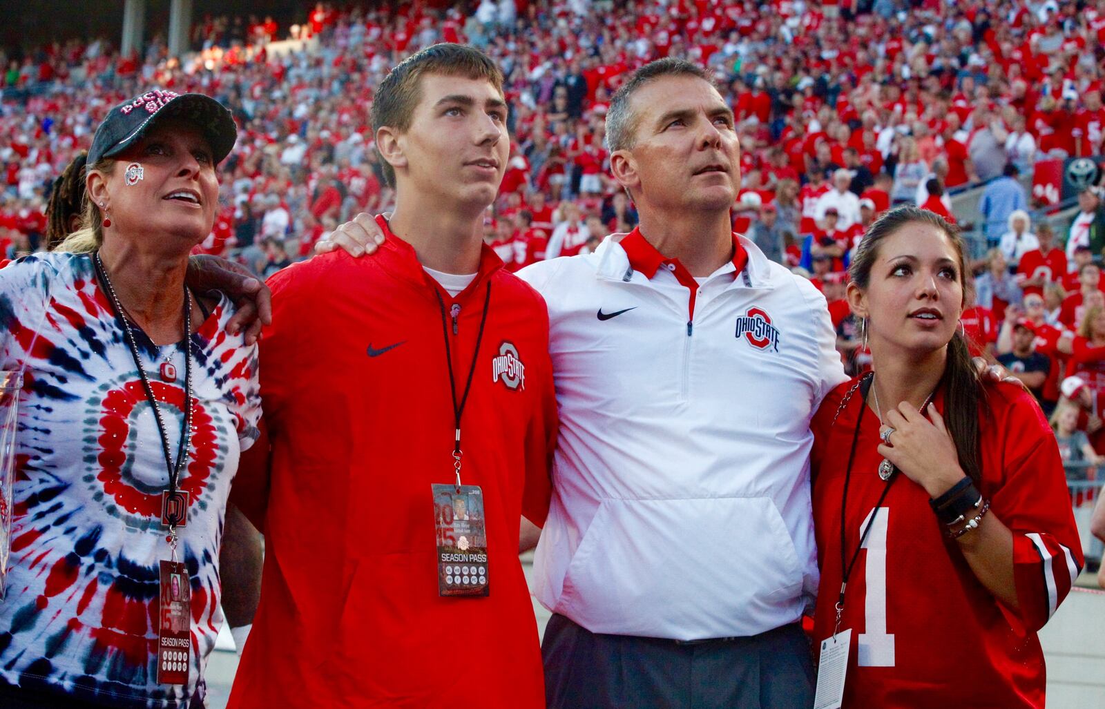 Ohio State coach Urban Meyer sings the fight song with his wife Shelley, left, son Nathan and daughter Nicki after a victory against Northern Illinois on Saturday, Sept. 19, 2015, at Ohio Stadium in Columbus. David Jablonski/Staff