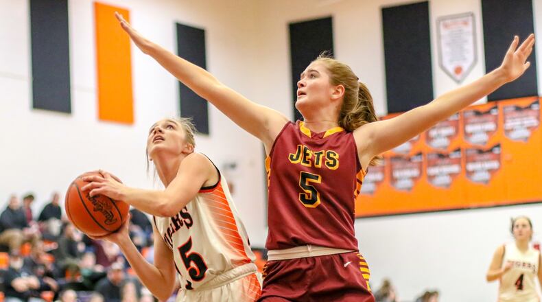 Northeastern junior Katie Baneck (right) defends Grace Estes of West Liberty-Salem last season. MICHAEL COOPER / CONTRIBUTED
