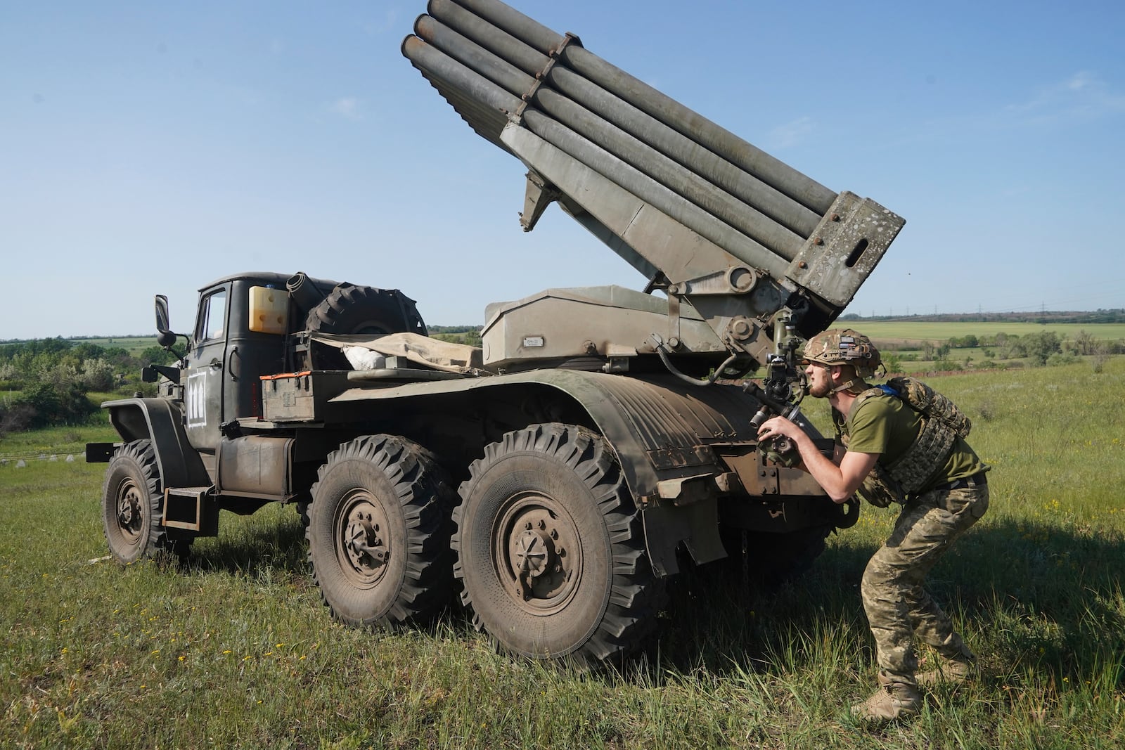 A soldier of Ukraine's 30th Separate Mechanized Brigade prepares to fires a Grad multiple rocket launcher towards Russian positions at the frontline in Donetsk region, Ukraine, Tuesday, June 3, 2025. (AP Photo/Andrii Marienko)