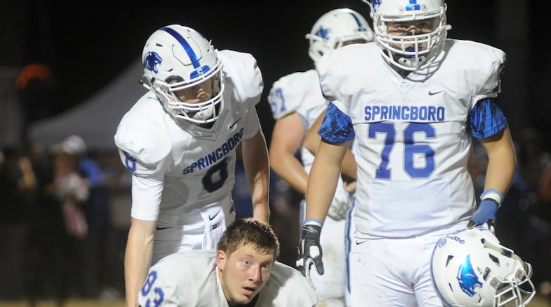Springboro’s Justin Rigg (83) is helped by teammates Elijah Cunningham (8) and Justin Fontana after a hard it. Miamisburg defeated visiting Springboro 35-32 in the final regular-season high school varsity football game at Harmon Field on Friday, Oct. 23, 2015. MARC PENDLETON / STAFF