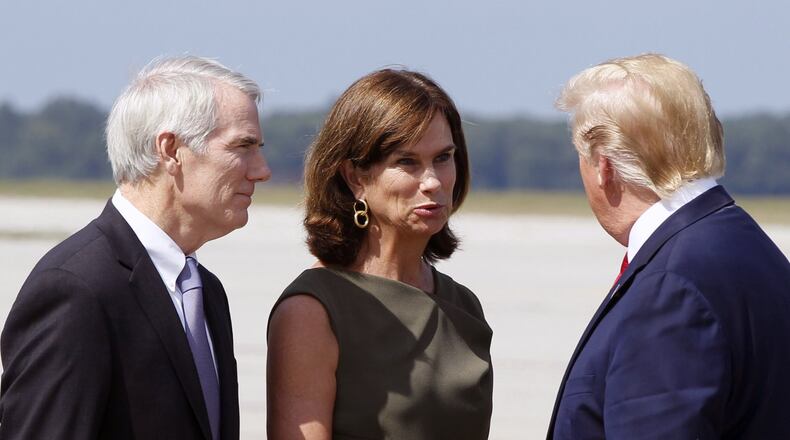 U.S. Senator Rob Portman and his wife Jane are greeted by President Trump at Wright-Patterson Air Force Base, Wednesday, Aug. 7, 2019, in Dayton, Ohio. TY GREENLEES/STAFF
