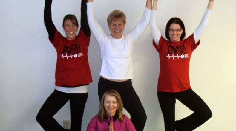 Julie Lamm (front row seated) teaches Yoga weekly at various offices in the area. Pictured with her (L r) are students Kim Doherty, Cris Peterson and Ellen Duncil.