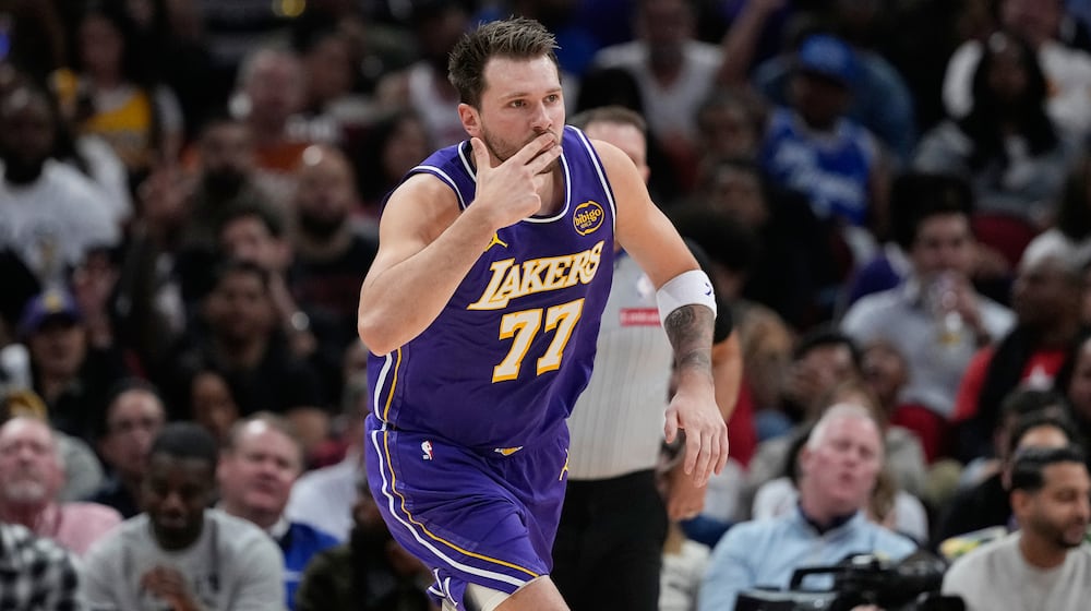 Los Angeles Lakers' Luka Doncic celebrates after making a 3-pointer against the Houston Rockets during the first half of an NBA basketball game Wednesday, March 18, 2026, in Houston. (AP Photo/David J. Phillip)