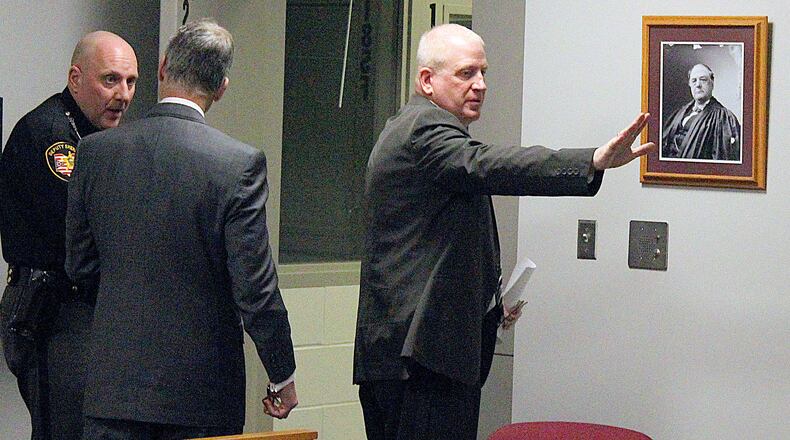 Former Indian Lake superintendent (right) Patrick O’Donnell waves good-bye to family and friends as he leaves a Logan County courtroom after being sentenced to four and one half years in prison during a sentencing hearing. JEFF GUERINI/STAFF