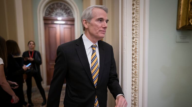 FILE - In this Jan. 31, 2020, file photo Sen. Rob Portman, R-Ohio, arrives as the impeachment trial of President Donald Trump on charges of abuse of power and obstruction of Congress resumes in Washington. Pressure is increasing on a Trump administration official to authorize a formal transition process for President-elect Joe Biden. Portman of Ohio on Monday, Nov. 23, called for the head of the General Services Administration to release money and staffing needed for the transition. (AP Photo/J. Scott Applewhite, File)