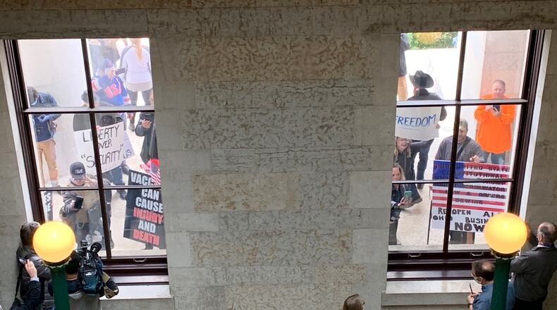 Protesters demonstrate outside the Statehouse Friday, May 1, 2020. LAURA A. BISCHOFF / STAFF