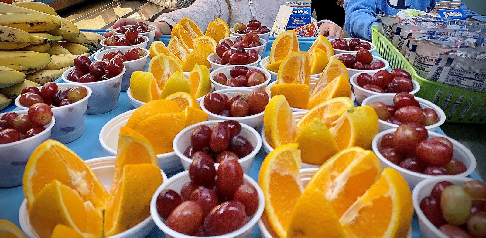 Fruit for school lunches are arranged for students on Tuesday Sept. 13, 2022 at Indian Riffle Elementary School in Kettering. MARSHALL GORBY\STAFF