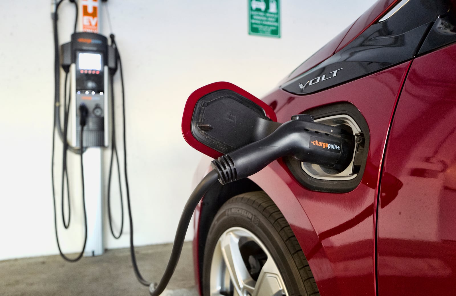 FILE - A Chevrolet Volt hybrid car is seen charging at a ChargePoint charging station at a parking garage in Los Angeles, Oct. 17, 2018. (AP Photo/Richard Vogel, File)