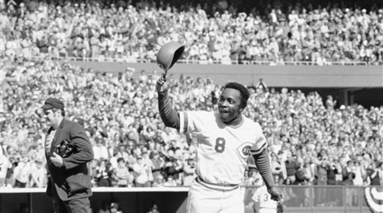 Cincinnati's speedy second baseman Joe Morgan tips his helmet to the fans as he rounds the bases after a homer in the first inning against the Yankees on Saturday, Oct. 16, 1976 in Riverfront Stadium. (AP Photo)