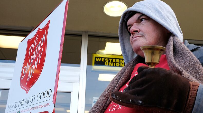 Joseph Pash rings a bell outside a grocery store as he collects money for the Salvation Army in Springfield. Bill Lackey/Staff