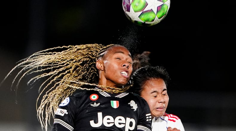 OL Lyonnes's Alice Sombath, right, jumps for the ball with Juventus' Lindsey Thomas during the women's Champions League soccer match between Juventus and OL Lyonnes in Biella, Italy, Wednesday, Nov. 19, 2025. (Fabio Ferrari/LaPresse via AP)