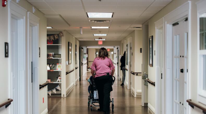 FILE — A nursing home employee with a patient at a nursing home in Worthington, Pa., on March 23, 2021. Experts agree that more nurses and aides mean better care, but there’s no consensus on how many is ideal. The right ratio also depends on how frail a nursing home’s residents are. (Kristian Thacker/The New York Times)