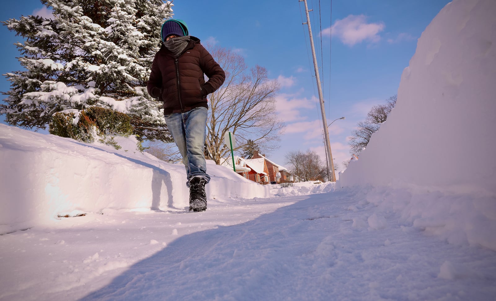 A man walks down Harding Road in Springfield, one of the few areas where sidewalks were cleared of snow as of Monday afternoon, Jan. 26, 2026. CONTRIBUTED BY MARSHALL GORBY